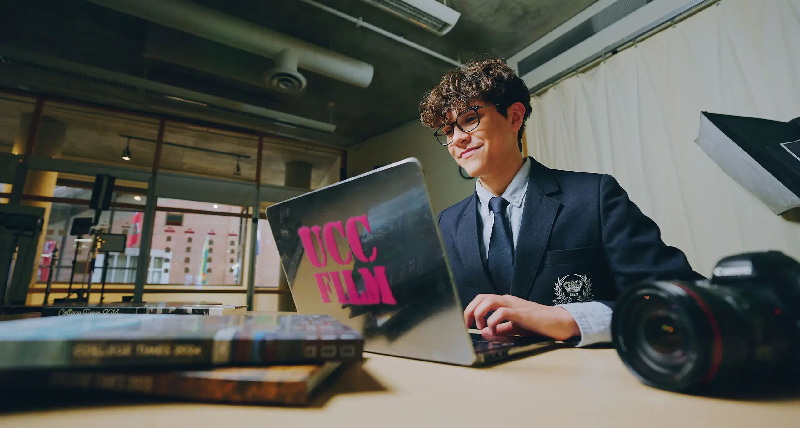Student Doing Classwork on Laptop and Smiling