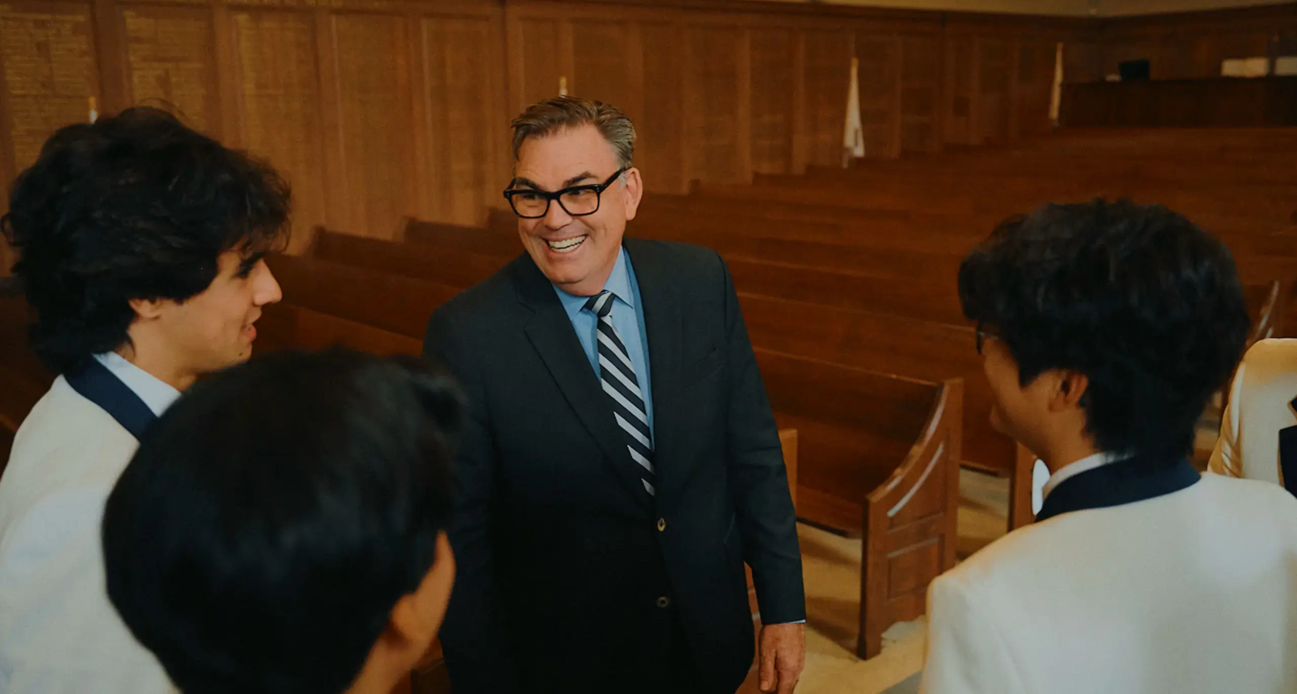 Principal of UCC Talking with Students and Smiling
