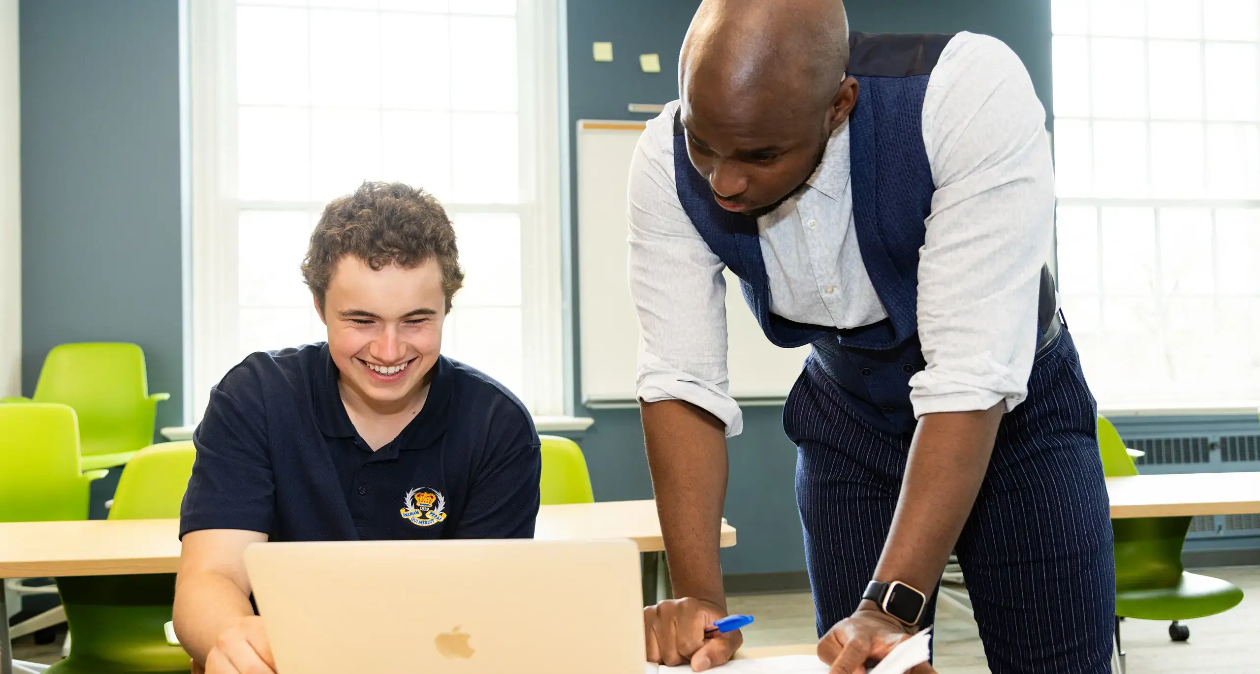 Teacher Helping Student in Class