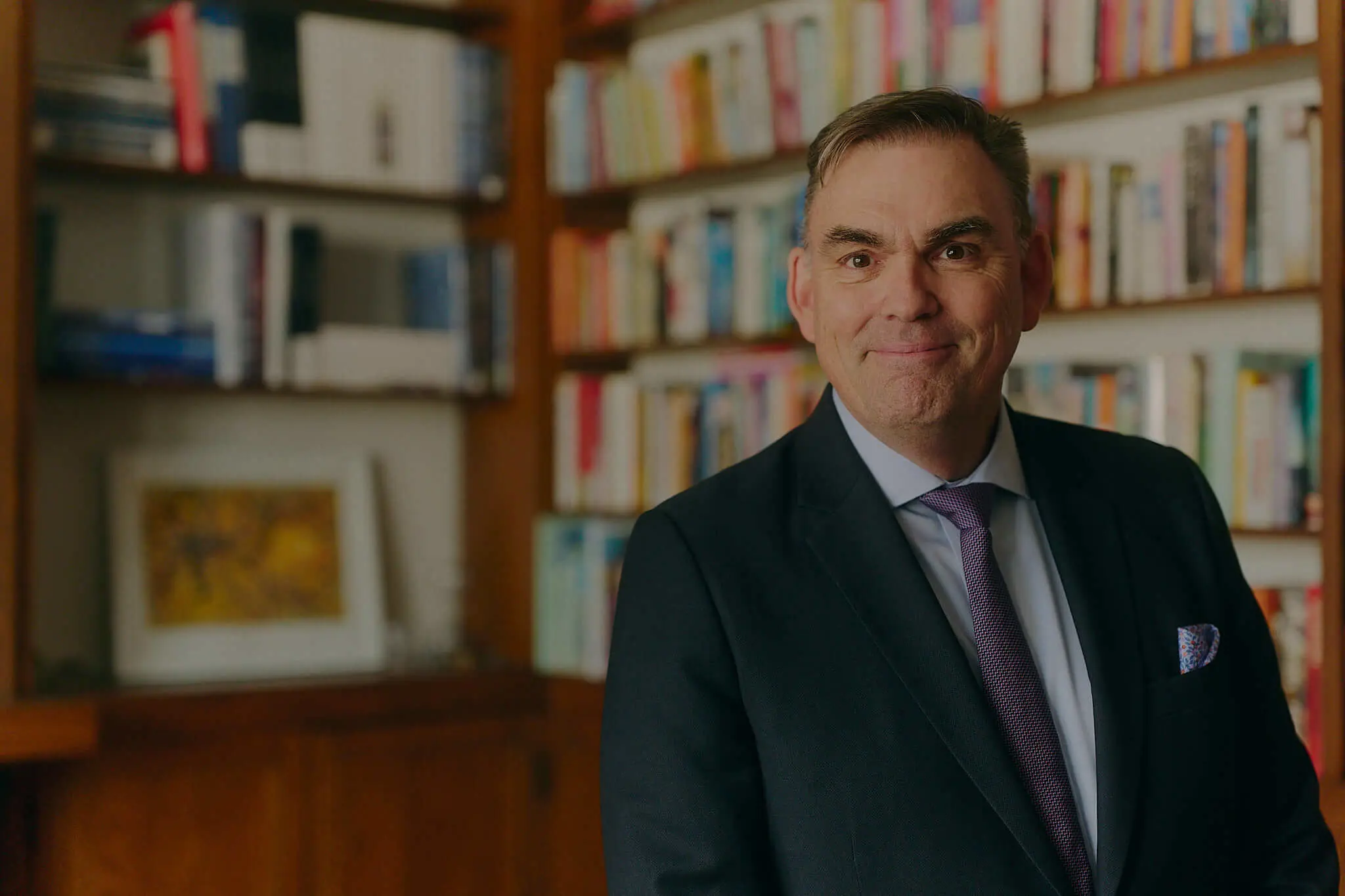 Principal Sam McKinney in an office library setting