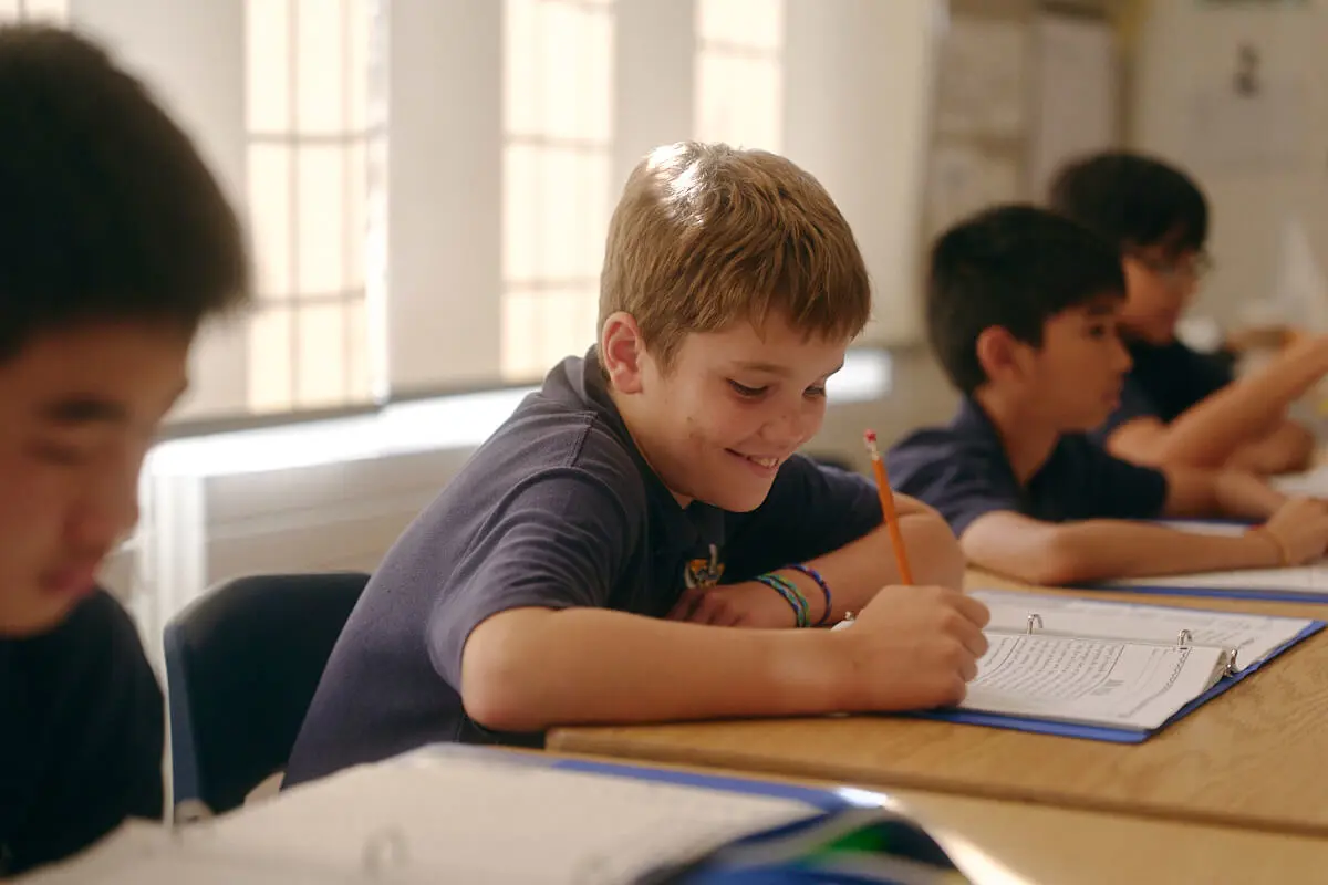 Student writing in notebook
